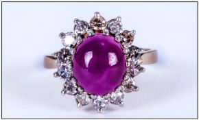 A 1930`s Cabochon Cut Star Ruby and Diamond Cluster Ring. The Central Star Ruby Surrounded By 16