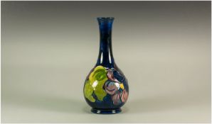 Moorcroft `Clematis` Pattern Bottle Vase, deep purple, dark pink and cobalt blue tubelined