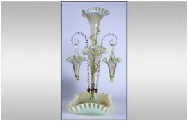 Victorian Vaseline Glass Epergne with two hanging bride baskets and 2 flutes, all with crinkly