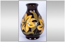 Moorcroft Globual Shaped Vase, `Bermuda Lily` Design, on chocolate ground. Circa 1955-75. Stands 7.