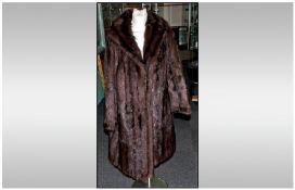 Ladies Full Length Dark Brown Musquash Coat, fully lined. Collar with revers. Slit Pockets.