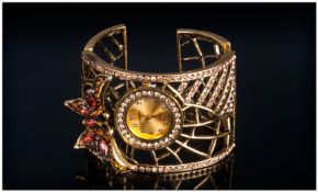 Butterfly Cuff Fashion Watch, the openwork cuff enhanced with champagne crystals, including a frame