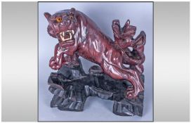 An Oriental Hard Wood Carving of a Tiger on a rocky formation, with glass eyes and bone teeth. 9