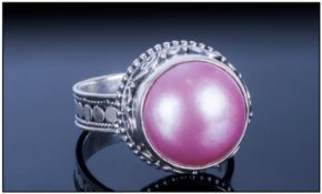 Pink Fresh Water Mabe Pearl Ring, the 14mm solitaire pearl which has developed with a flat