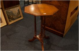 An Edwardian Hexagonal Shaped Top Centre Table in an elm wood finish. On three column base.