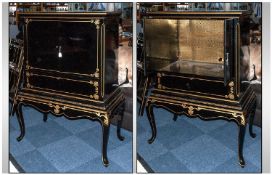 Black Lacquered Revolving Cabinet on shaped cabriole leg stand, decorated in gilt work, the two