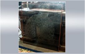 A Large Smoky Brown Glass Window with a deep engraving of a peacock in all its glory. 43 by 46