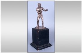 An Early 20th Century Silver Figure Of A Boxer Raised on Black Wooden Plinth standing 8`` in