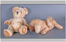 Beige Colour Teddy c 1938, squeaky tummy and glass eyes. Together with straw filled doggy soft toy.