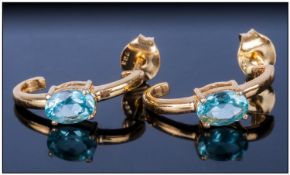 Pair of Apatite J-Hoop Earrings, 1ct of the bright, turquoise blue, oval cut apatite in an unusual