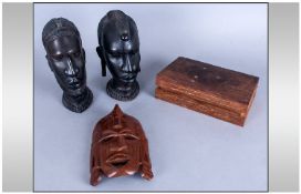 A Pair of Carved Ebony African Heads, together with a carved mask and a brass inlaid wooden box.