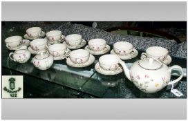 German Tea Set, comprising 11 cups & saucers, tea pot, sugar bowl. Floral design on cream ground.