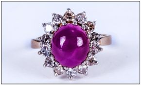 A 1930's Cabochon Cut Star Ruby and Diamond Cluster Ring. The Central Star Ruby Surrounded By 16
