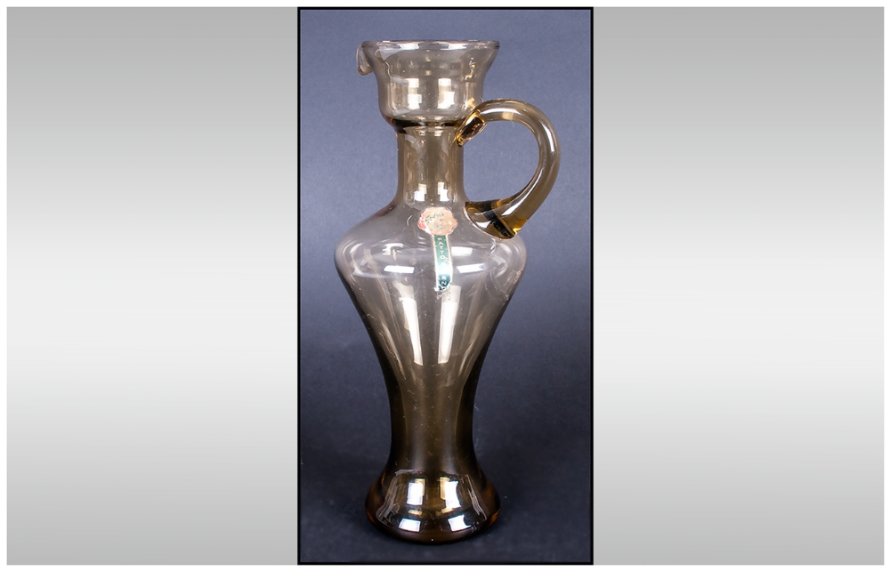 Emboli - Shaped Glass Jug, Labelled. Stands 7.25 Inches High, Excellent Condition.