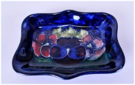Moorcroft Shaped Small Pin Tray ' Pansy ' Design on Blue Ground. c.1920's. Diameter 4 Inches.