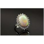 18ct White Gold Opal and Diamond Cluster Ring. The Large Opal Surrounding by 20 Small Diamonds,