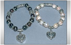 Pair of Fresh Water Pearl Charm Bracelets, one white and one peacock pearl, both interspersed with