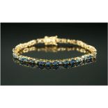 Blue Sapphire and White Sapphire Tennis Bracelet, rows of three oval cut blue sapphires