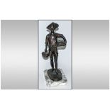 A 20th Century French Bronze Figure Of A Young Fisher Boy carrying baskets of fish. Raised on a