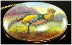 An Early 20th Century Oval Hand Painted Porcelain Brooch of a Gold Pheasant In a Woodland Setting.