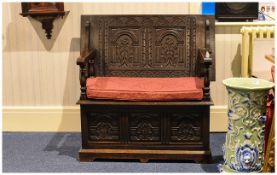 Carved Oak Lift Up Top Marks Bench with a Lift up Seat Below Three Carved Panels Supported by Turned