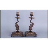 Pair Antique Florentine Cast Bronze Candlesticks in the form of a Dolphin Holding up the Sconces, On