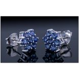 Tanzanite Cluster Earrings, each a cluster of seven round cut tanzanites in a flower or star