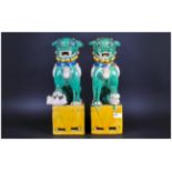 Sanchai Ware Temple Foo Dogs In The Traditional Coloured Glazes, The Pair Seated on a Square Pierced