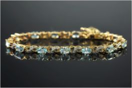 9ct Gold Diamond & Topaz Bracelet, Set With Oval Blue Topaz Between Diamond Set Links, Fully