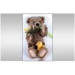 Steiff Mohair Teddy Bear, holding a bunch of flowers with a chick to one leg.
