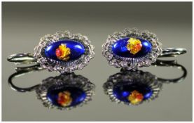 Pair Of 18ct White Gold Earrings, Set With A Central Blue Enamelled Cabochon With Floral Decoration,