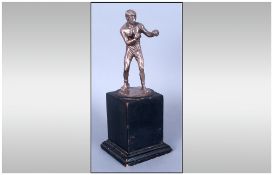 An Early 20th Century Silver Figure Of A Boxer Raised on Black Wooden Plinth standing 8'' in height.