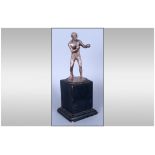 An Early 20th Century Silver Figure Of A Boxer Raised on Black Wooden Plinth standing 8'' in height.