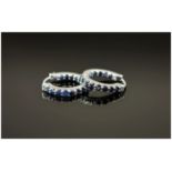 Blue Sapphire Hoop Earrings, the round cut sapphires set in a single row to the front of the hoop,