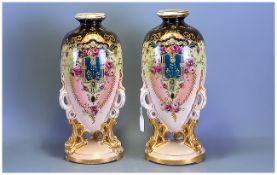 Pair of Floral Decorated Staffordshire Vases of unusual shape, standing on three gilded legs. 18