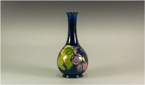 Moorcroft 'Clematis' Pattern Bottle Vase, deep purple, dark pink and cobalt blue tubelined clematis,