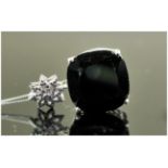 Black Spinel Cushion Cut Pendant, a 25ct black spinel in a filigree mount, suspended from a