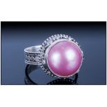 Pink Fresh Water Mabe Pearl Ring, the 14mm solitaire pearl which has developed with a flat underside