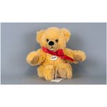 Steiff Bear 'Bobby' yellow fur with red bow. Steiff button to ear with label & booklet still