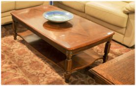 Reproduction Coffee Table With A Veneered Top, cross banded of oblong shape, the square reeded