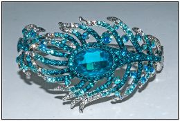 Turquoise and White Crystal Peacock Feather Bangle, the single stylised peacock feather encrusted