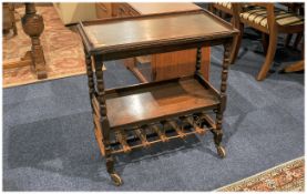 1930's Turn Leg Oak Twist Top Tea Table with a later added wine rack. 26 inches in diameter and 30