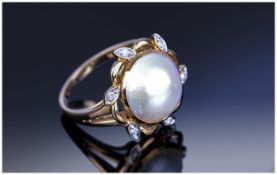 18ct Gold Dress Ring Set With A Central Split Pearl And 6 Diamond Chips In A Flowerhead Setting,