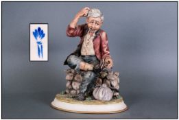Capodimonte Signed & Early Figure 'Tramp Sitting On A Wall, Shoes Worn' signed to base. Stands 9.25"