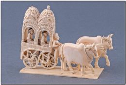 Indian Late 19th Century Ivory Figure Group. Indian carriage with seated figures pulled by two oxen,