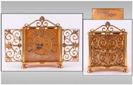 I.M.H.O.F Clock Company High Grade Gilt Metal Mantel Clock. With openwork doors, winding eight day