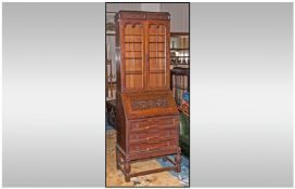1930s Carved Oak Glazed Topped Bureau Bookcase, with a carved fall front and fitted interior.