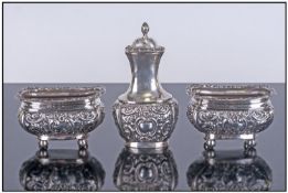 Victorian 3 Piece Silver Cruet Set. With embossed decoration to bodies and borders supported on ball