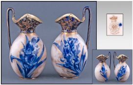 Pair of Doulton Burslem Ovoid Ewers, bunches of blue iris on the gilt speckled cream bodies, below