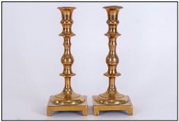 Pair Of Heavy Cast Brass Antique Candlesticks, with a knopped stem on a Square footed base.